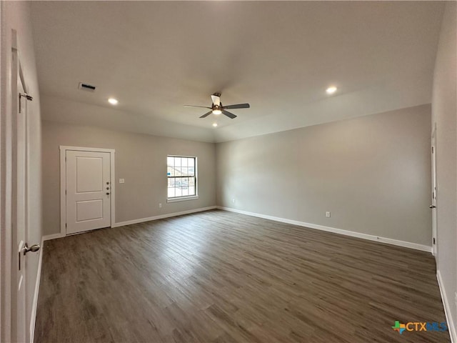 empty room featuring ceiling fan and dark hardwood / wood-style flooring