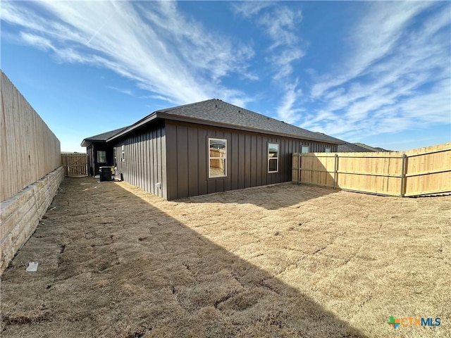 back of property featuring central AC