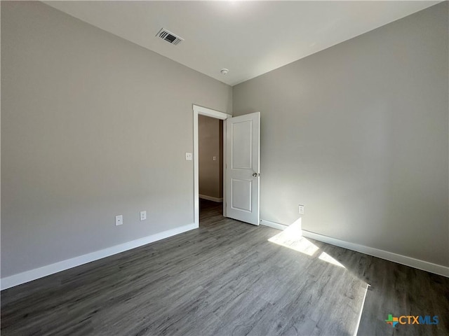 unfurnished room featuring dark hardwood / wood-style floors