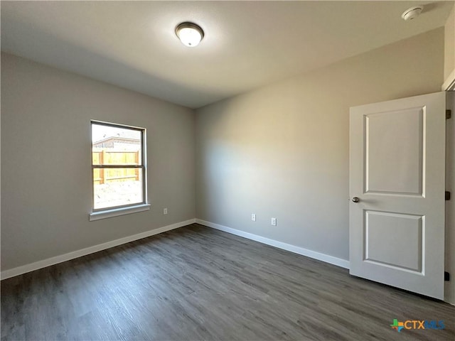 spare room with dark hardwood / wood-style flooring