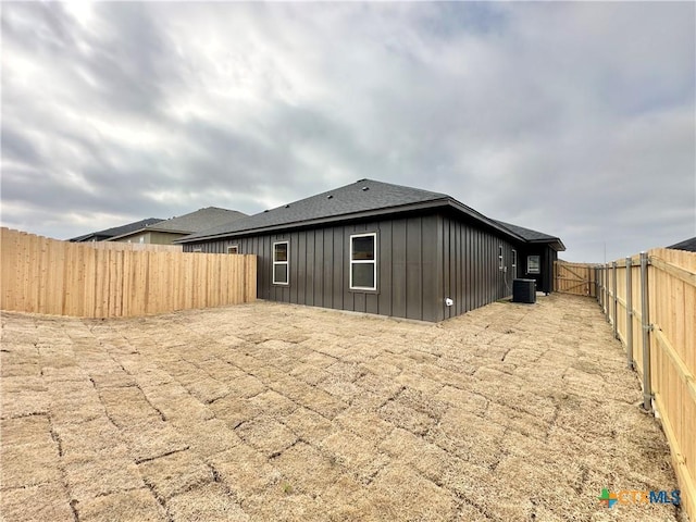 rear view of property featuring a patio area and central air condition unit