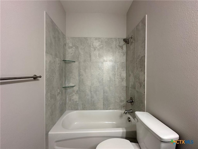 bathroom featuring tiled shower / bath and toilet