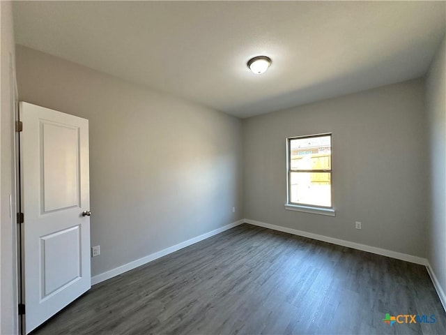 spare room with dark hardwood / wood-style floors