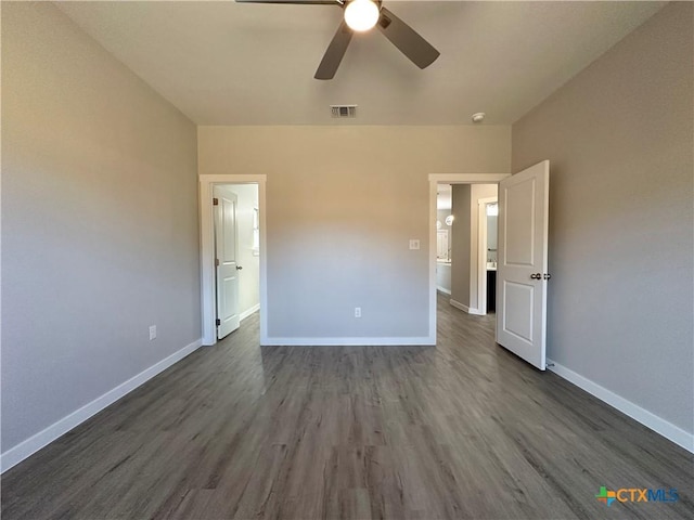 unfurnished bedroom featuring dark wood-type flooring and ceiling fan