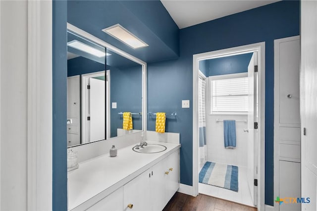 2506 Bon Aire Ave, Victoria, TX 77901 - full bathroom featuring vanity, wood finished floors, and baseboards