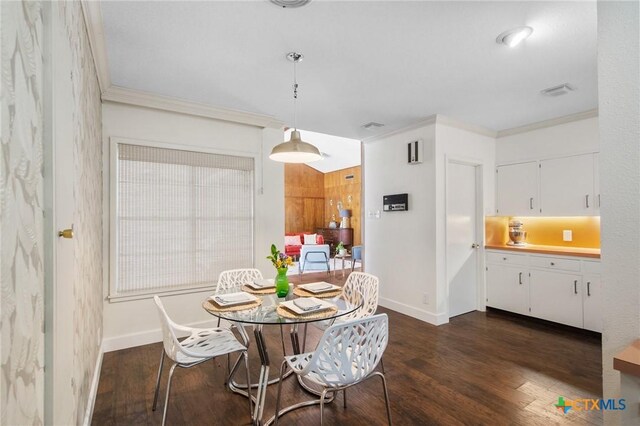 2506 Bon Aire Ave, Victoria, TX 77901 - dining space featuring ornamental molding, dark wood-style floors, and baseboards