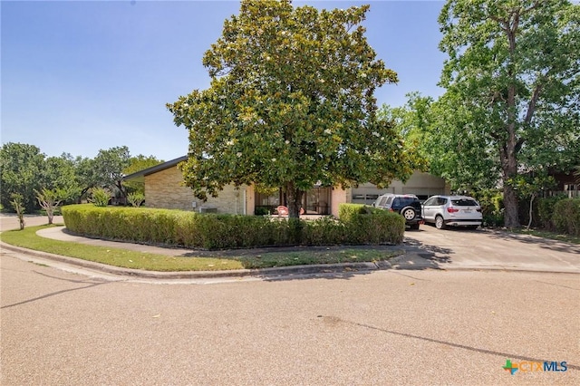 2506 Bon Aire Ave, Victoria, TX 77901 - view of property hidden behind natural elements featuring driveway and a garage