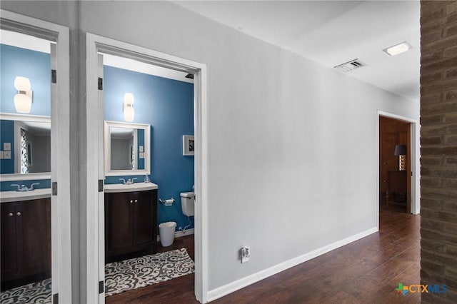 2506 Bon Aire Ave, Victoria, TX 77901 - hall featuring wood finished floors, baseboards, and a sink