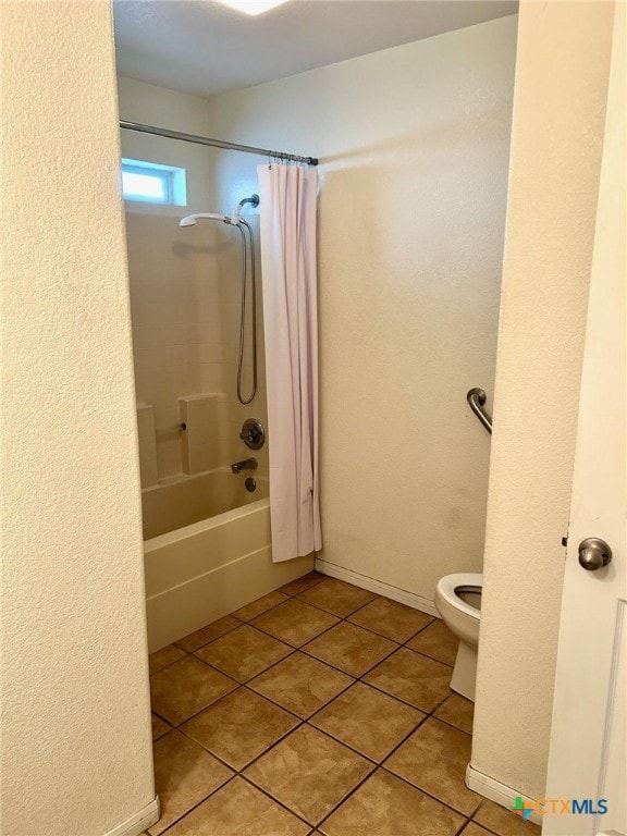 bathroom with tile patterned floors, toilet, and shower / tub combo with curtain