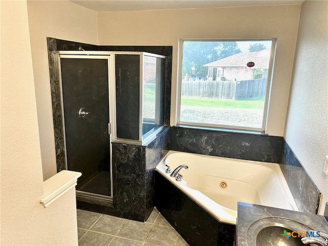 bathroom with tile patterned flooring, separate shower and tub, and sink