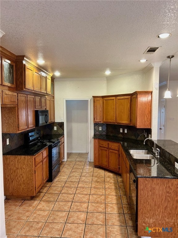 kitchen with tasteful backsplash, sink, black appliances, and decorative light fixtures