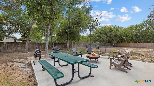 view of patio featuring a fire pit and a grill