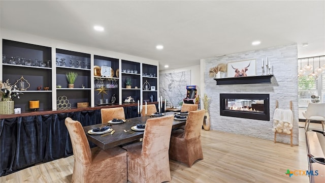 dining area featuring a fireplace and hardwood / wood-style flooring