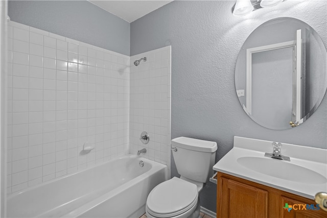 full bathroom featuring vanity, toilet, and tiled shower / bath combo