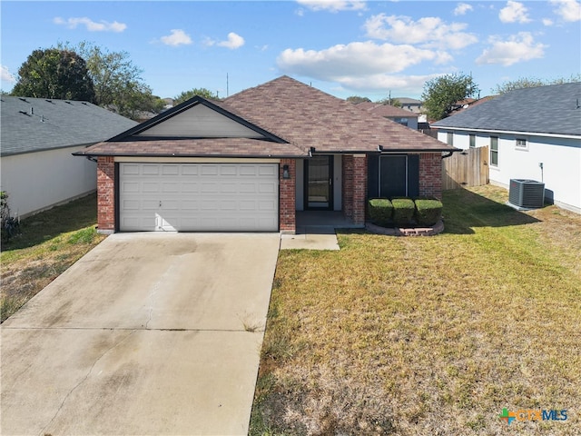 ranch-style home featuring a front lawn, central AC unit, and a garage