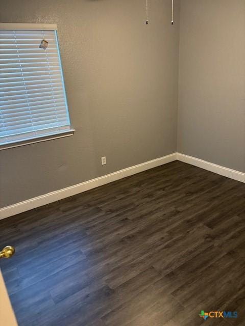 empty room featuring dark hardwood / wood-style flooring