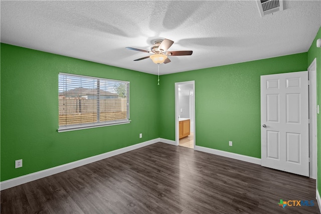 unfurnished bedroom with hardwood / wood-style floors, ceiling fan, and connected bathroom