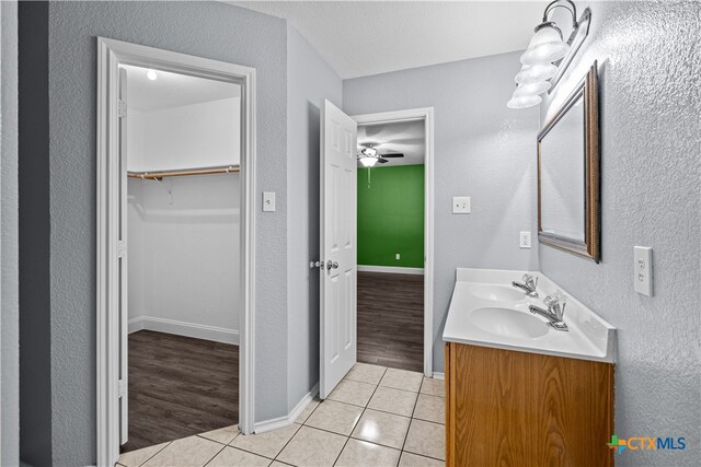 bathroom with ceiling fan, vanity, and hardwood / wood-style flooring