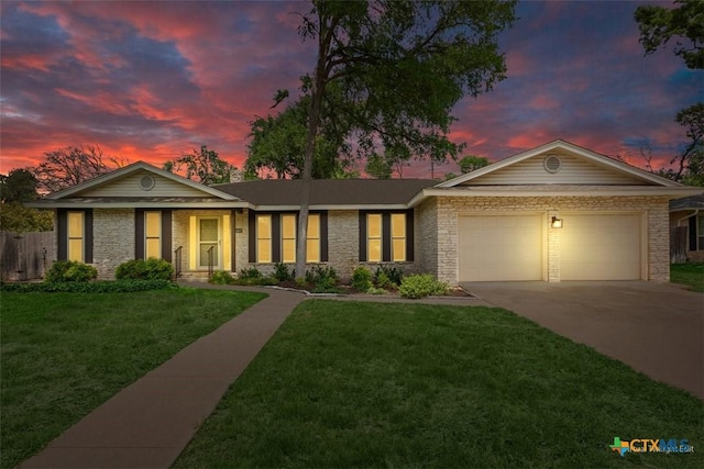 ranch-style home with an attached garage, a front yard, fence, and driveway