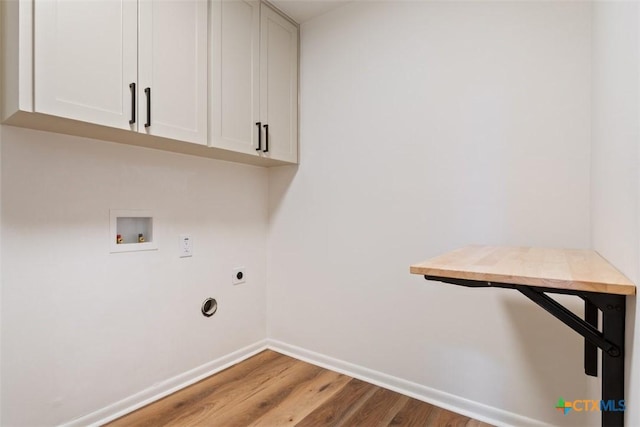 washroom featuring wood finished floors, baseboards, electric dryer hookup, cabinet space, and washer hookup