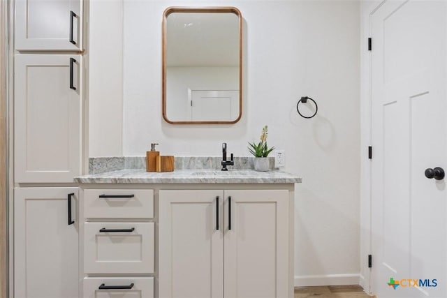 bathroom featuring baseboards and vanity