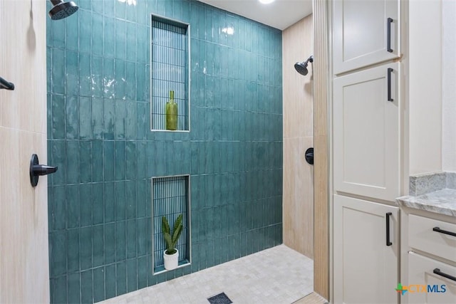 bathroom with vanity and a walk in shower