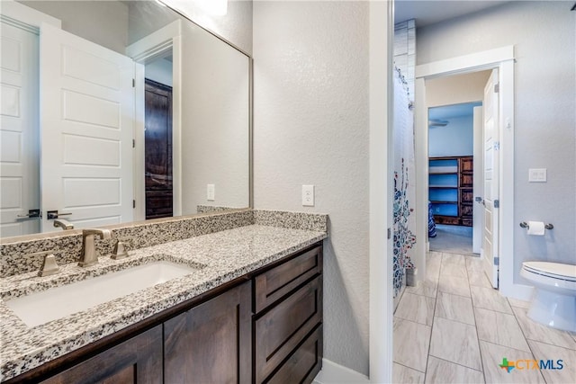 bathroom featuring vanity and toilet