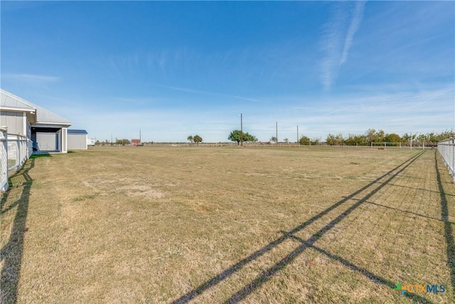 view of yard with a rural view