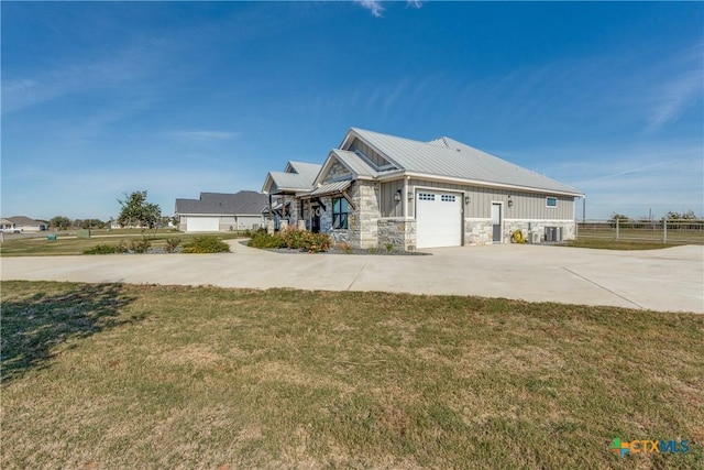 view of front of house with a garage and a front yard