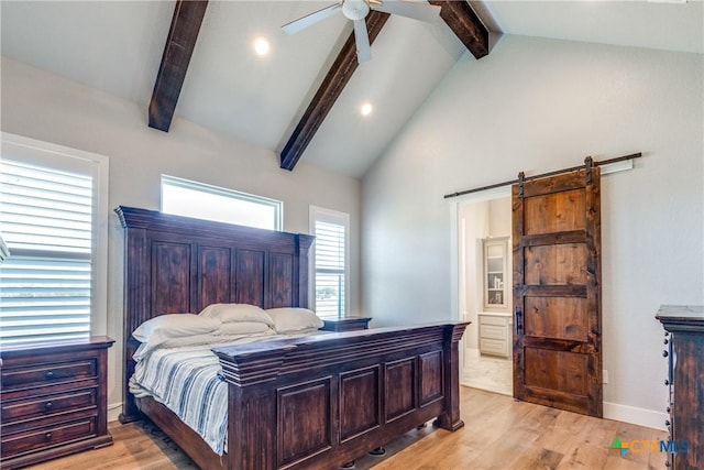 bedroom with beam ceiling, a barn door, light hardwood / wood-style floors, and ceiling fan