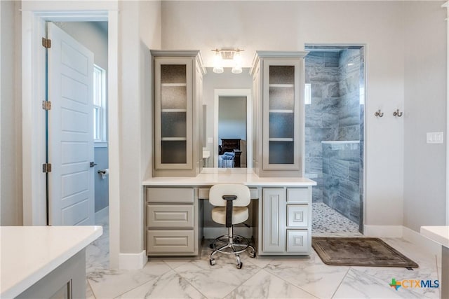 bathroom with vanity and tiled shower