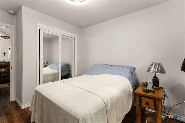 bedroom featuring dark hardwood / wood-style flooring and a closet