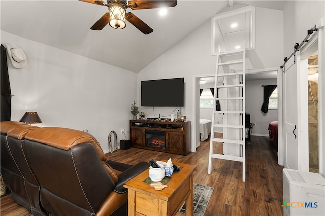 living room with dark wood-type flooring, high vaulted ceiling, a barn door, and ceiling fan