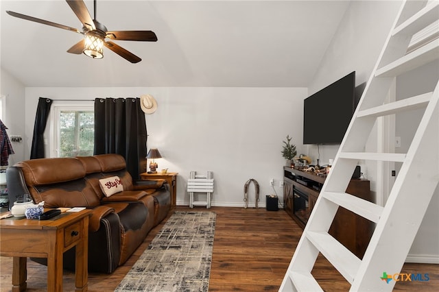 living room with dark hardwood / wood-style flooring, vaulted ceiling, and ceiling fan