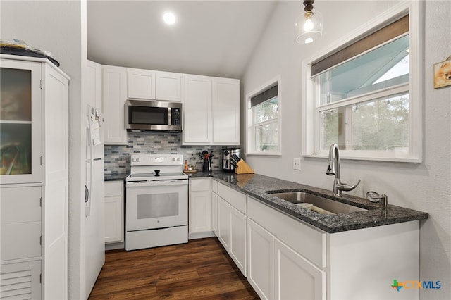 kitchen with vaulted ceiling, white range with electric stovetop, white cabinetry, sink, and dark stone countertops