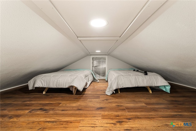 bedroom featuring lofted ceiling and hardwood / wood-style flooring