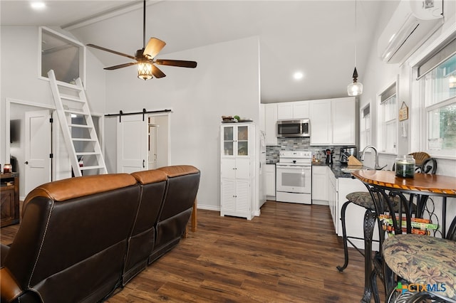 kitchen featuring a wall mounted air conditioner, white cabinetry, backsplash, white range with electric cooktop, and a barn door