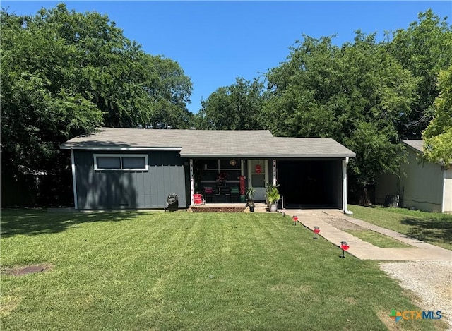 1506 S 39th St, Temple, TX 76504 - ranch-style house featuring a front yard, a porch, driveway, and a carport