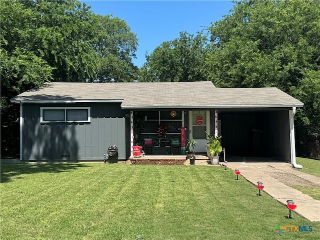 1506 S 39th St, Temple, TX 76504 - ranch-style home with a front yard, an attached carport, a porch, and board and batten siding