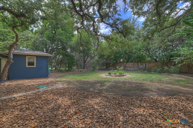 view of yard with an outdoor fire pit