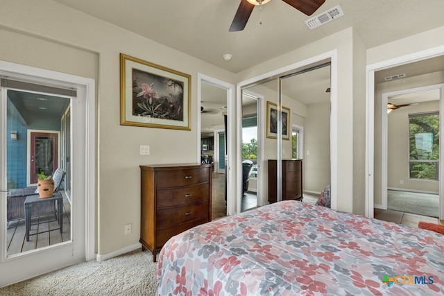 bedroom featuring light colored carpet, ceiling fan, and a closet