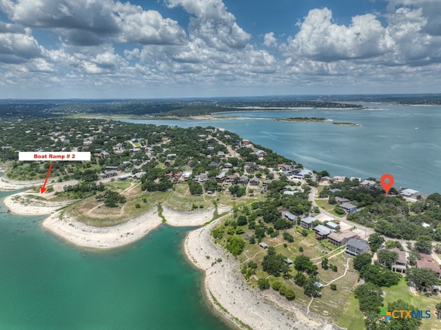 birds eye view of property featuring a beach view and a water view