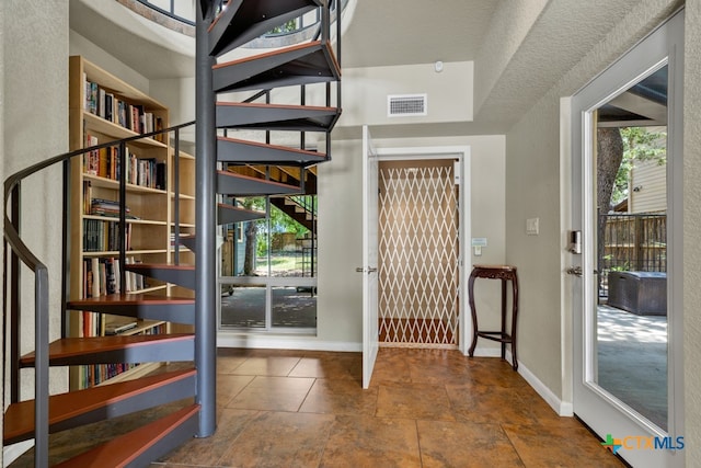 foyer with a textured ceiling