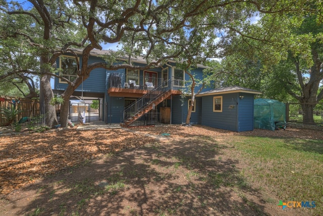 rear view of house featuring a deck