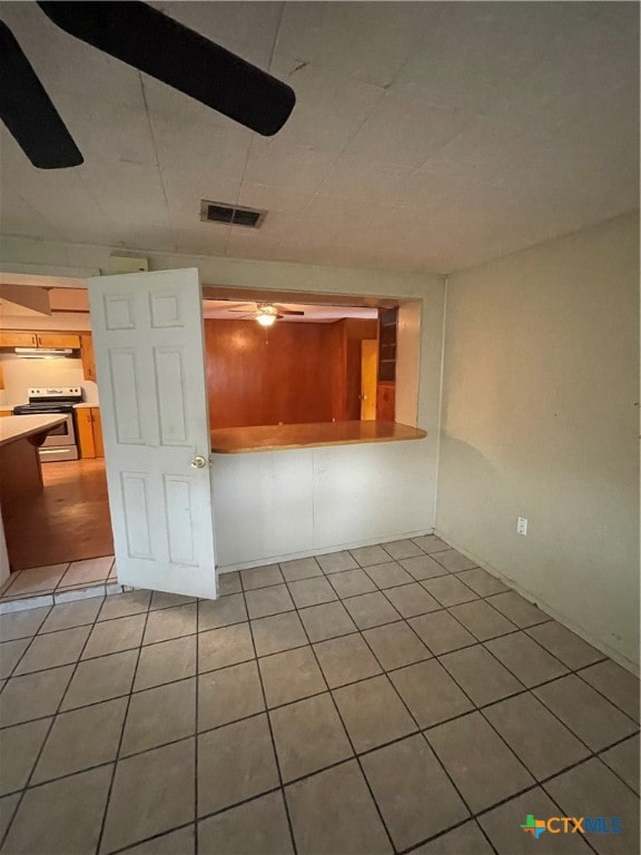 tiled empty room with ceiling fan