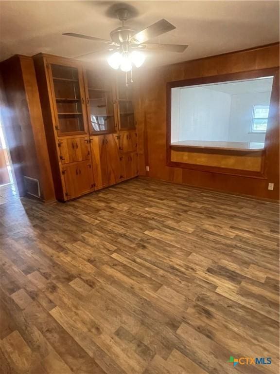 empty room with a ceiling fan and wood finished floors