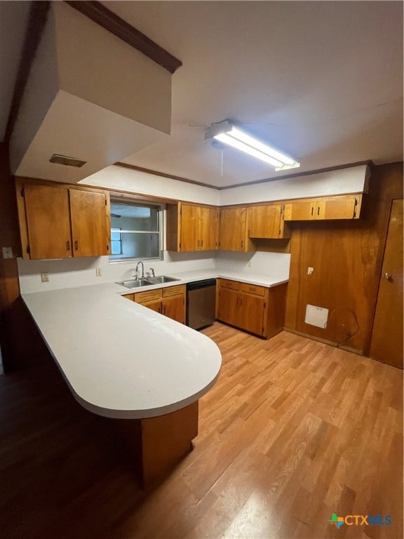 kitchen with dishwasher, kitchen peninsula, sink, and light hardwood / wood-style floors