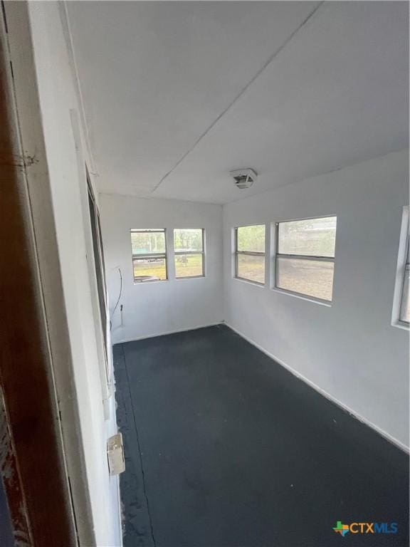 empty room with concrete flooring