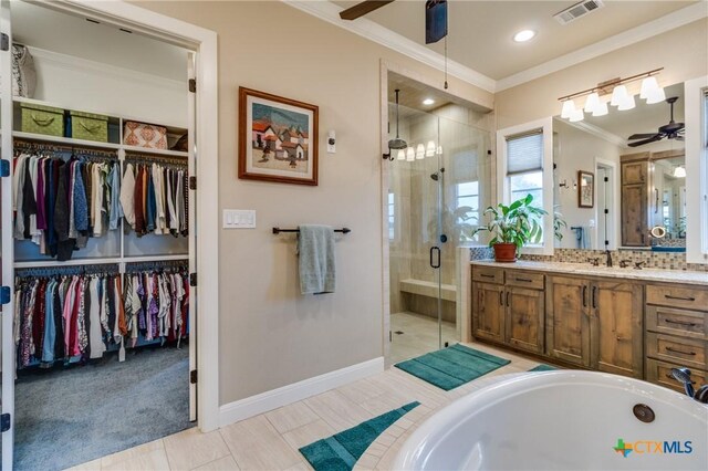 carpeted bedroom featuring crown molding and ceiling fan