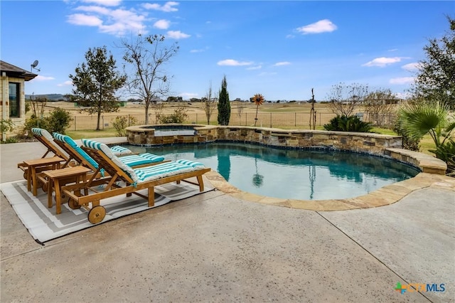 view of pool featuring a pool with connected hot tub, a patio area, and a fenced backyard